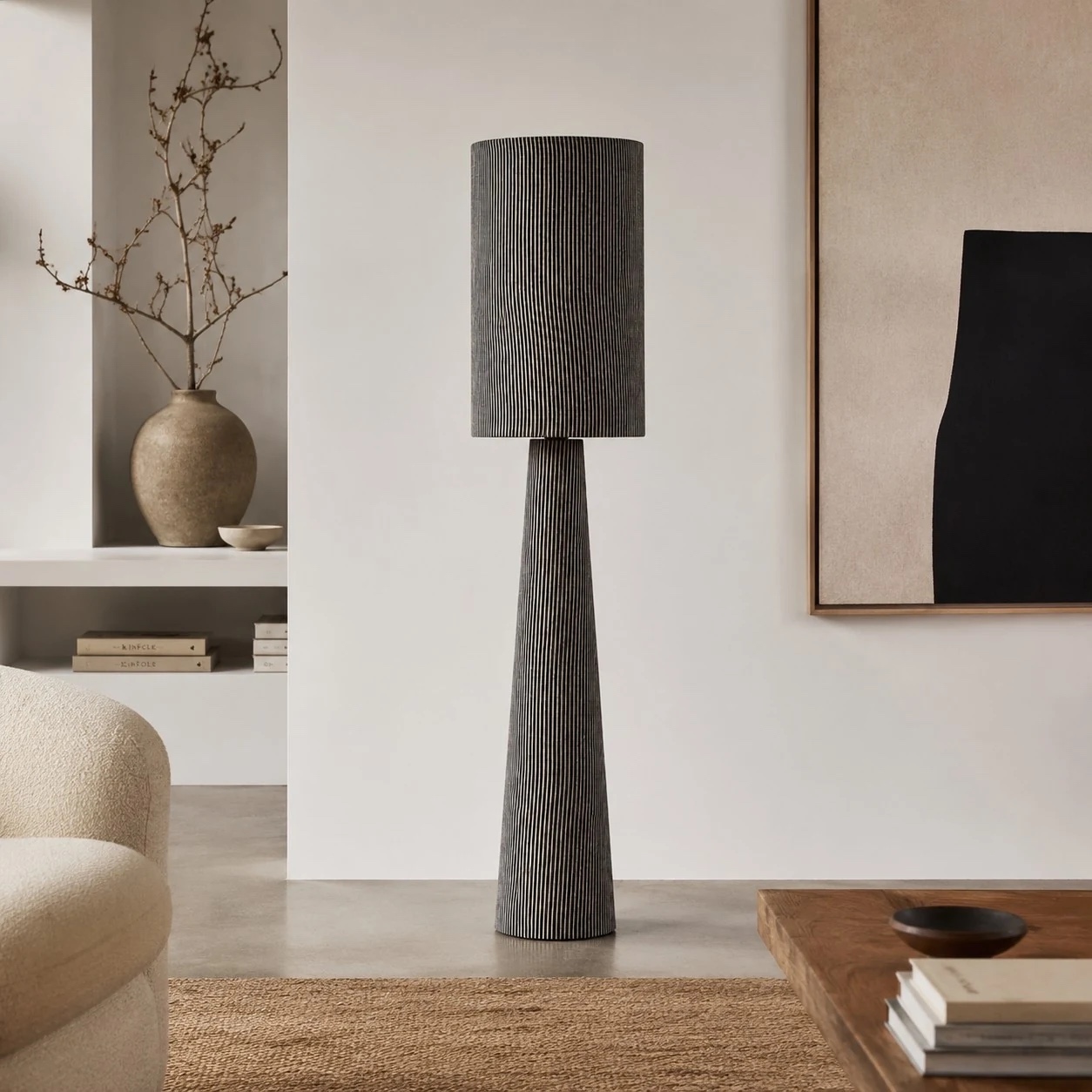 Tall gray striped floor lamp in a modern neutral room
