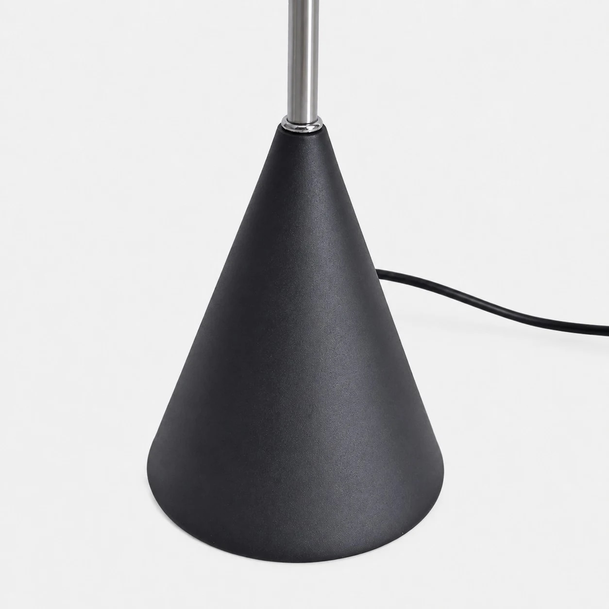Weighted black cone base and power cord detail