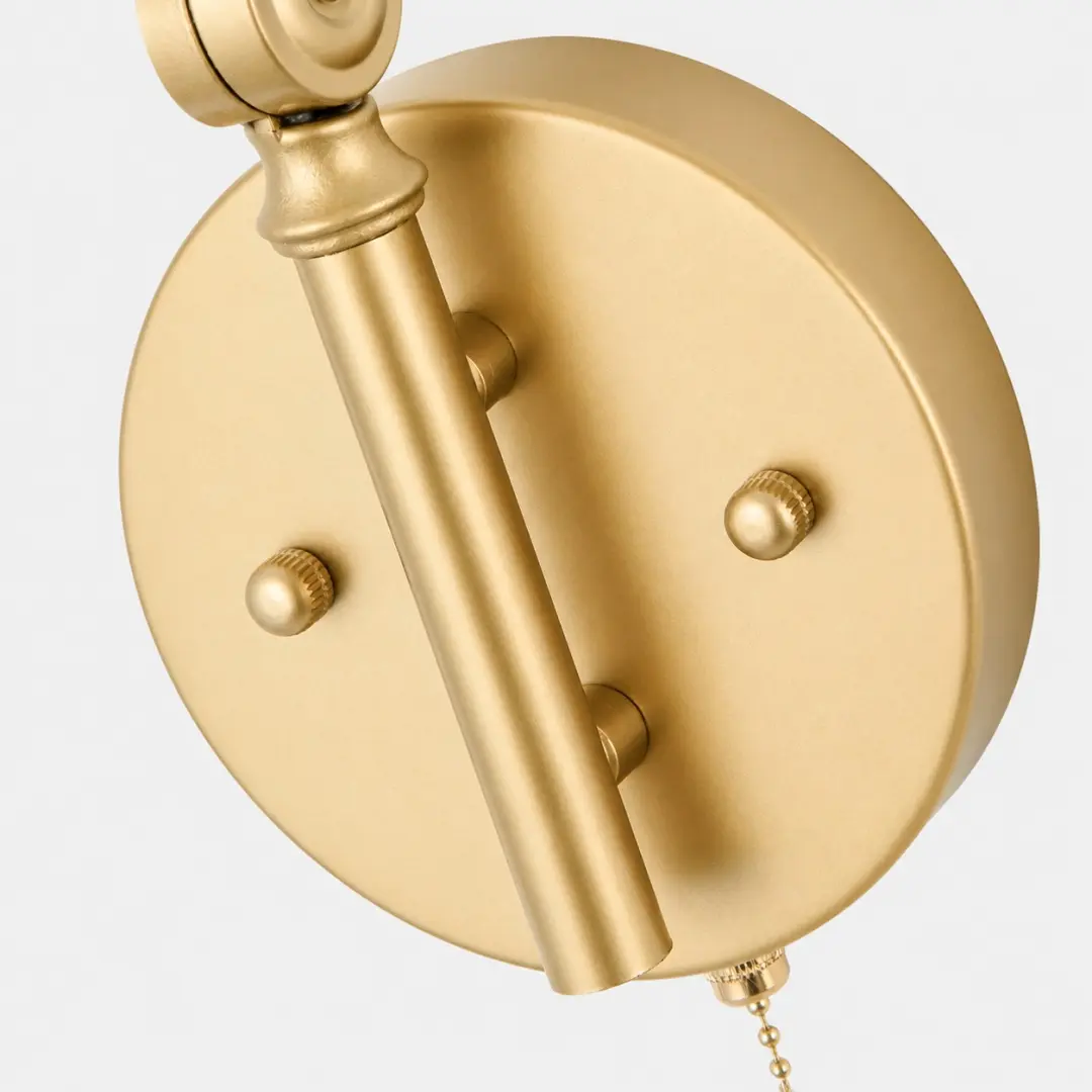 Gold wall plate and pull chain detail